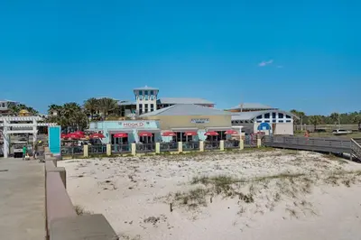 a beach with a restaurant and a building at Treasure Island Unit 2011: Sunset Sands, 2 Bed/2 Bath Retreat – Sleeps 8! in Panama City Beach