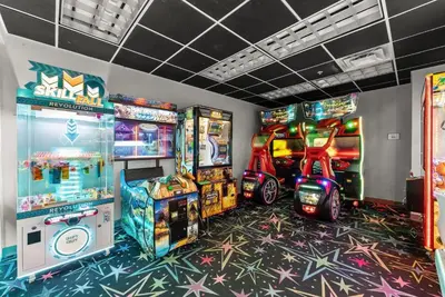 a room with arcade games and video game machines at Tidewater 715 in Panama City Beach
