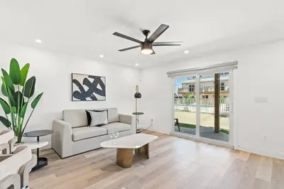 a living room with a couch and a ceiling fan at Ocean Breeze 1B in Panama City Beach