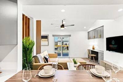 a dining room and living room with a table and chairs at Ocean Breeze 1D in Panama City Beach