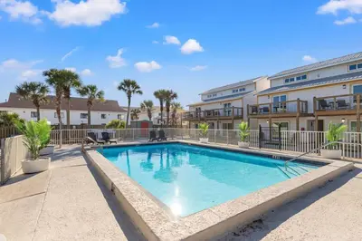 a swimming pool in the courtyard of a apartment building at Ocean Breeze 2C in Panama City Beach