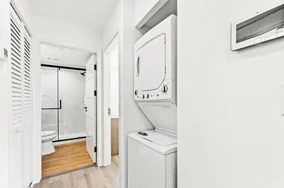 a white bathroom with a sink and a mirror at Ocean Breeze 2C in Panama City Beach