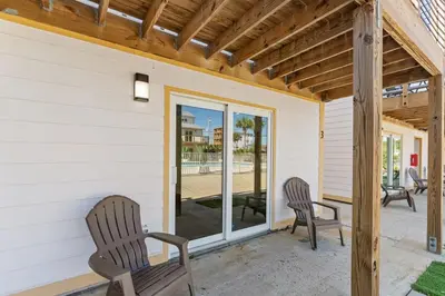 two chairs on the porch of a house at Ocean Breeze 2B in Panama City Beach
