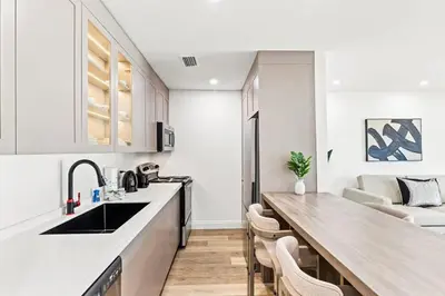 a kitchen with white cabinets and a wooden counter top at Ocean Breeze 2B in Panama City Beach
