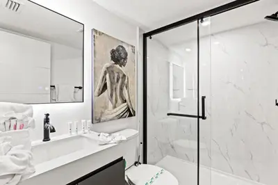 a bathroom with a shower and a toilet and a sink at Ocean Breeze 2D in Panama City Beach