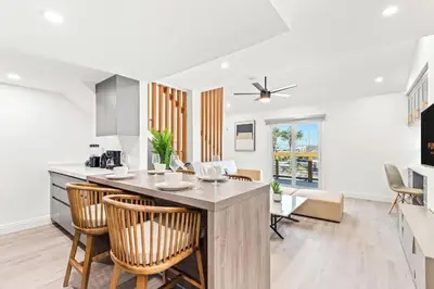 a kitchen and dining room with a counter and chairs at Ocean Breeze 3C in Panama City Beach