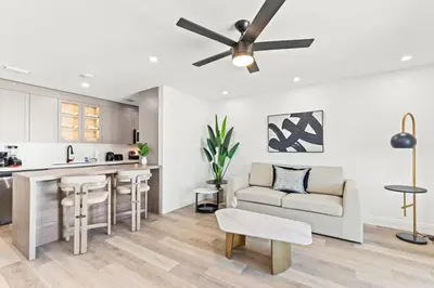 a kitchen and living room with a ceiling fan at Ocean Breeze 3A in Panama City Beach
