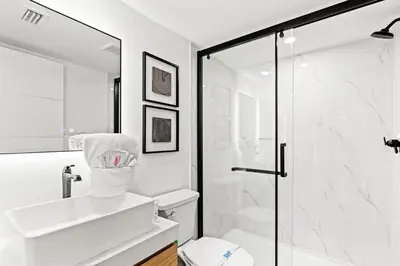a white bathroom with a shower and a toilet at Ocean Breeze 3A in Panama City Beach