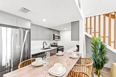a kitchen and dining room with a table and chairs at Ocean Breeze 3D in Panama City Beach