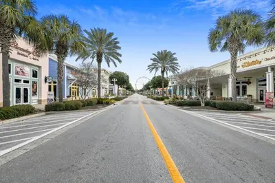 an empty street in a town with palm trees at Endless Summer A36 - 