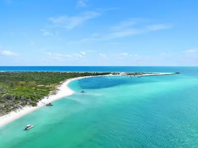 an island in the ocean with two boats in the water at Condo w/beach, pools, tennis, shuffleboard, more! in Panama City Beach