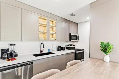 a kitchen with white cabinets and a counter top at Ocean Breeze 5B in Panama City Beach