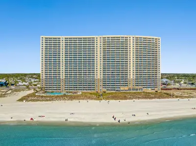 a large building on a beach next to the ocean at Emerald Beach Resort 1834 - Beachfront with Stunning Views by Beach Haven Vacation Rentals in Panama City Beach