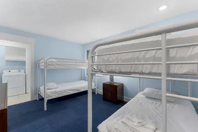 a bedroom with two bunk beds and a mirror at Sharkys Retreat 701 by Beach Haven Vacation Rentals in Panama City Beach
