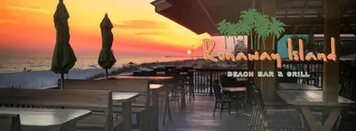 a beach bar and grill with tables and umbrellas at Origin 1329 - Studio King Gulf View - Sunrise Views by Beach Haven Vacation Rentals in Panama City Beach