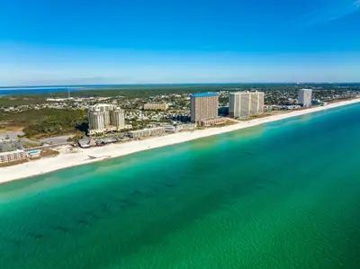an aerial view of a beach with buildings and the ocean at Origin 1329 - Studio King Gulf View - Sunrise Views by Beach Haven Vacation Rentals in Panama City Beach