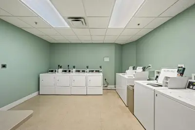 a room with white appliances in a room with blue walls at Origin 1315 - Studio King - Super Cute Unit - City View by Beach Haven Vacation Rentals in Panama City Beach