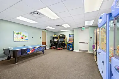 a room with a pool table and arcade games at Origin 1211 - One Bedroom - Spacious Partial Gulf View by Beach Haven Vacation Rentals in Panama City Beach
