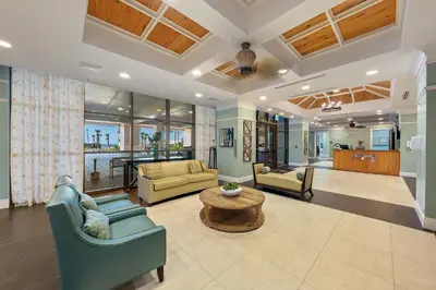a living room with two couches and a table at Origin 1024 - One Bedroom - Sunny Pool Deck & Gulf Views by Beach Haven Vacation Rentals in Panama City Beach