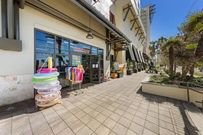 a store on a street with a stack of towels at Origin 1023 - Studio King - Peaceful Nature View Unit by Beach Haven Vacation Rentals in Panama City Beach
