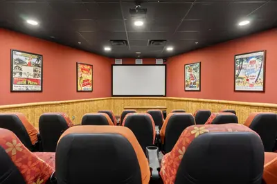 a conference room with red walls and a screen at Origin 1005 - Studio King - Stunning Gulf Views by Beach Haven Vacation Rentals in Panama City Beach