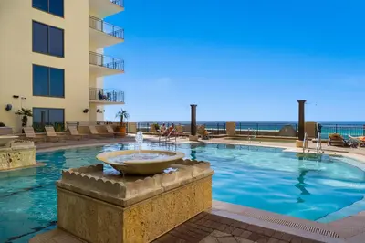 a swimming pool with a fountain in front of a building at Origin 0833 - Studio King - Sunrise & Gulf View by Beach Haven Vacation Rentals in Panama City Beach
