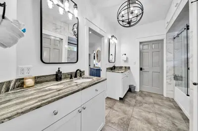 a bathroom with two sinks and a large mirror at Saltaire in Santa Rosa Beach