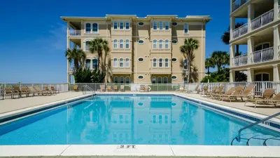 a swimming pool in front of a building at Villas At Sunset Beach B201 in Panama City Beach