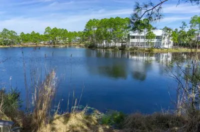 a view of a lake with a building in the background at Beachside Villas 1211 in Santa Rosa Beach