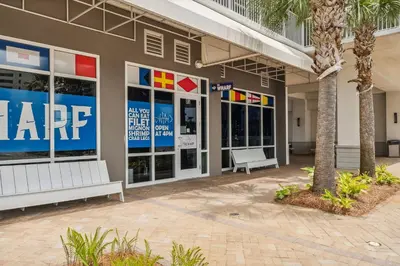 a large building with two benches in front of it at Laketown Wharf #0703 in Panama City Beach