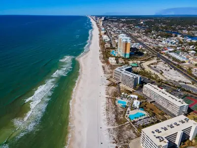 an aerial view of a beach with buildings and the ocean at Dunes of Panama C605 in Panama City Beach