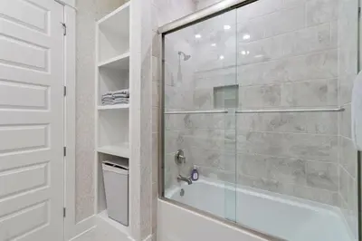 a bathroom with a shower with a glass door at Seas the Day in Inlet Beach