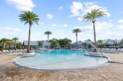 a large swimming pool with palm trees in a resort at Coastal Beauty in Inlet Beach