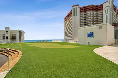 a golf course with a green field and buildings at Laketown Wharf #1919 in Panama City Beach