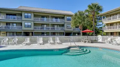 a hotel with a swimming pool in front of a building at Beachwood Villas 1C in Santa Rosa Beach