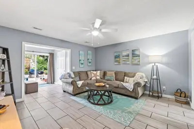 a living room with a couch and a table at Pet-Friendly Coastal Townhome | Walk to Beach & Local Dining in Panama City Beach