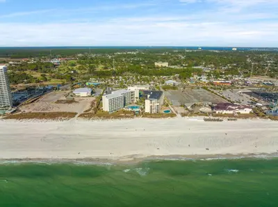 an aerial view of a beach with buildings and the ocean at Beachfront Studio Condo - Top of the Gulf 317 in Panama City Beach