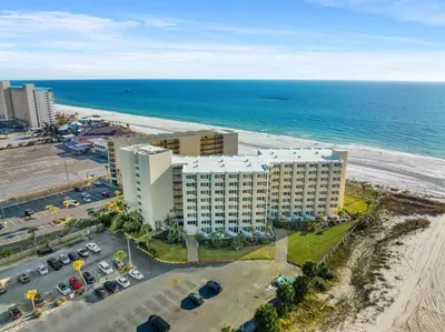 an aerial view of a building next to the beach at Beachfront Studio Condo - Top of the Gulf 317 in Panama City Beach