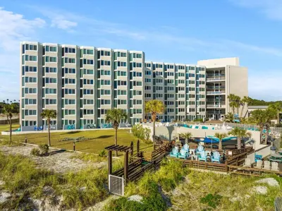 a large building with a pool and a resort at Beachfront Studio Condo - Top of the Gulf 317 in Panama City Beach
