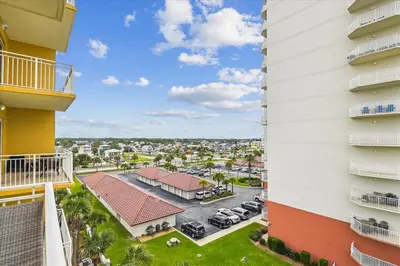 a view from the balcony of a building with a parking lot at 305 Sterling Beach in Panama City Beach