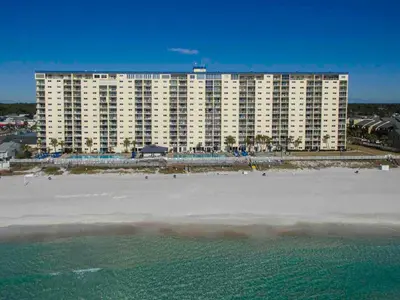 a large building on the beach next to the ocean at Regency Towers PCB #1006 in Panama City Beach