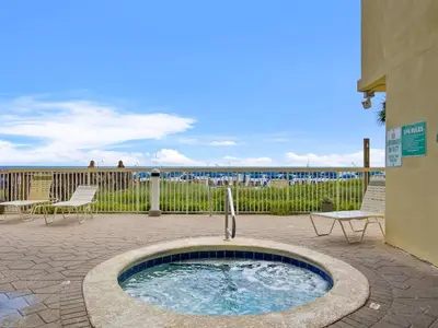 a hot tub in a patio with a view of the ocean at Celadon #0606 in Panama City Beach