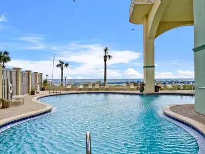 a swimming pool in a resort with palm trees at Celadon #0606 in Panama City Beach