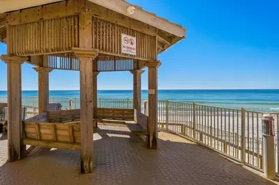 a wooden gazebo on a beach with the ocean at Treasure Island #2303 in Panama City Beach