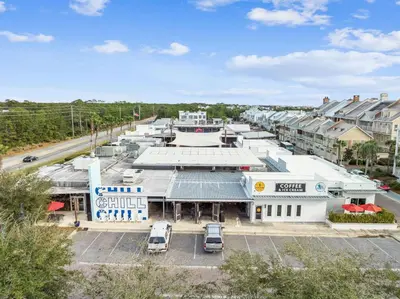 an aerial view of a building with cars parked in a parking lot at Restfull Dwelling in Inlet Beach