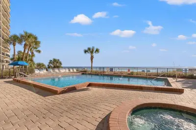 a large swimming pool next to the beach at Commodore 0702 in Panama City Beach