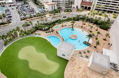 an overhead view of a pool in a resort at Resort-Style Lake-View Condo, 5 Pools, Hot Tubs, Walk to Beach in Panama City Beach