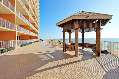 a gazebo next to a building next to the beach at Treasure Island 511 in Panama City Beach