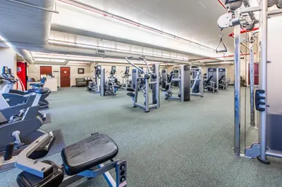 a gym with lots of treadmills and machines at Majestic Beach Towers 2-1703 by Emerald Coast Retreats in Panama City Beach
