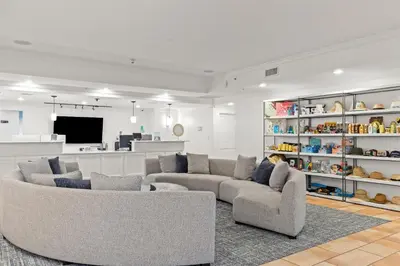 a living room with two couches and a tv at Grand Panama Beach Resort - Pet Friendly Condos by Panhandle Getaways in Panama City Beach